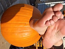Pumpkin sitting on a footstool