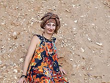 With spear wearing in colorful dress